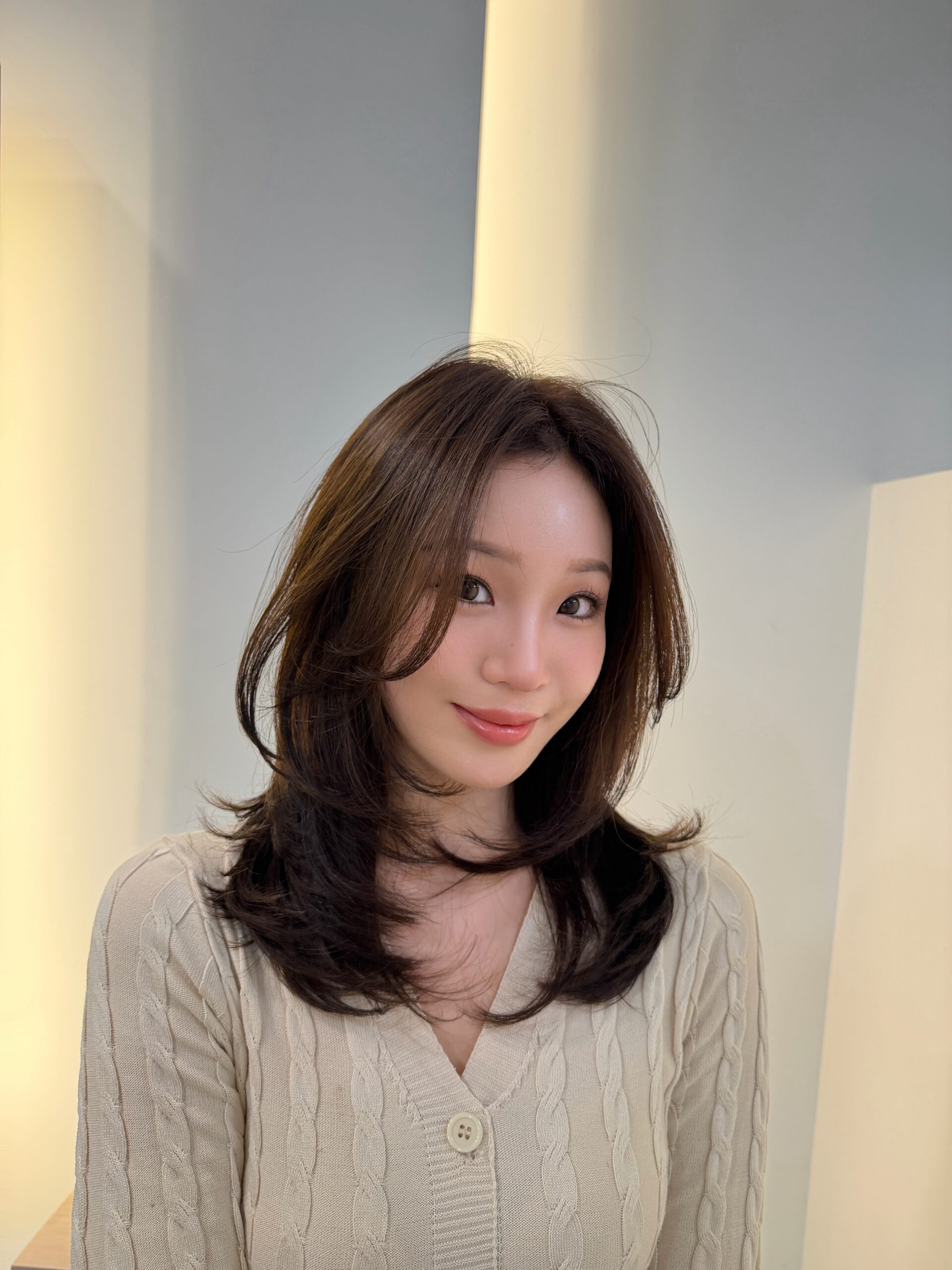 Medium-length layered hair with C-curls